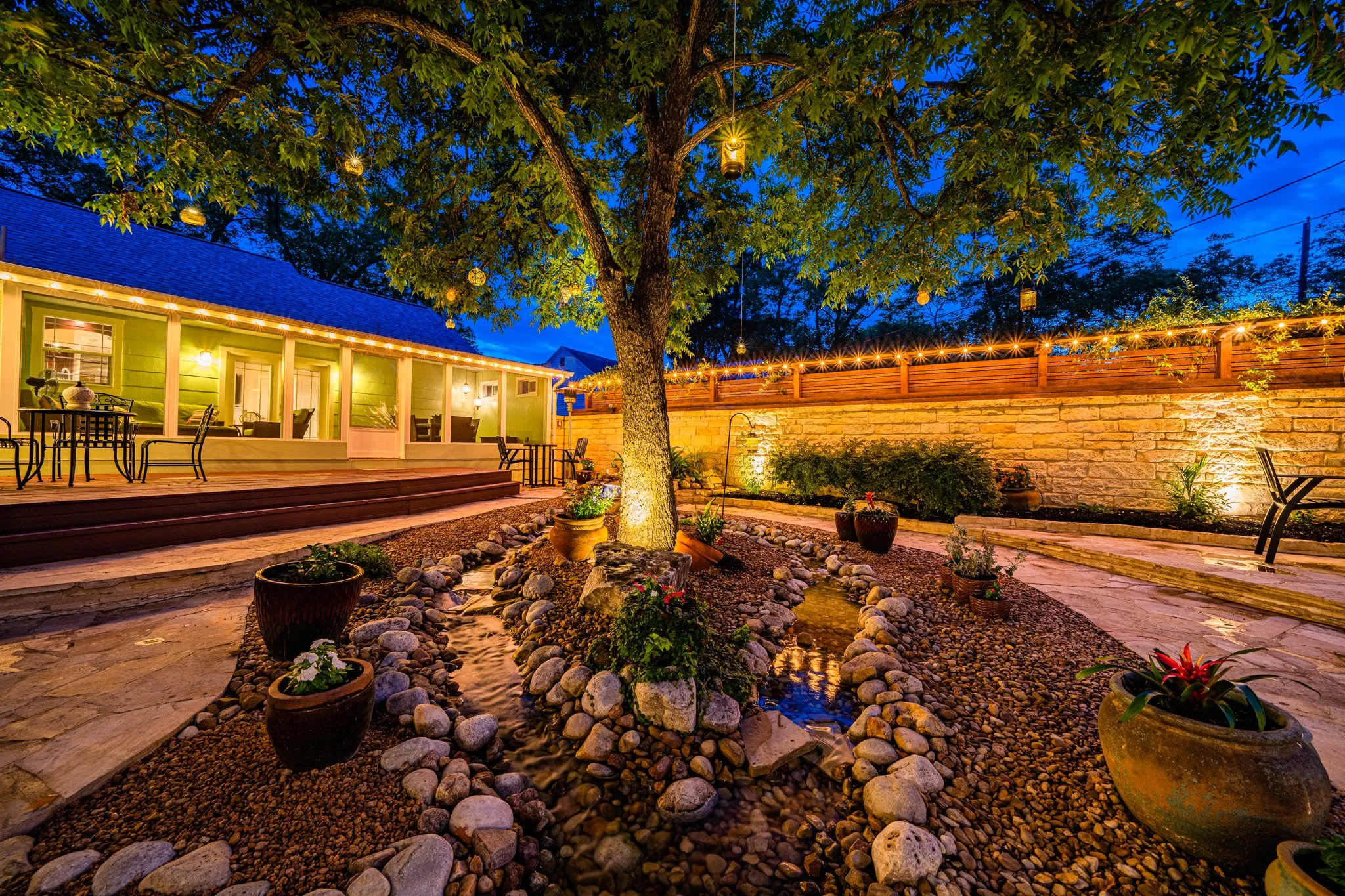 Backyard garden oasis with string lights and outdoor dining at a co-hosted vacation rental in the Texas Hill Country